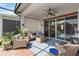 Charming covered patio with brick flooring, comfortable wicker seating, and a ceiling fan for outdoor enjoyment at 2503 Yellow Brick Rd, St Cloud, FL 34772