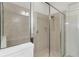 Tiled glass-enclosed shower with built in shampoo shelf and overhead lighting at 2503 Yellow Brick Rd, St Cloud, FL 34772