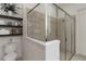 Modern bathroom showcasing a glass-enclosed shower and decoratively styled shelves at 2503 Yellow Brick Rd, St Cloud, FL 34772