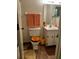 Well-lit bathroom featuring a toilet, tile floors, and vanity with storage space at 2659 Crown Ct # 11, Kissimmee, FL 34741