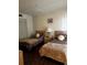 Cozy bedroom featuring twin beds, matching nightstand, and a closet at 2659 Crown Ct # 11, Kissimmee, FL 34741