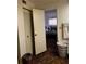 Bedroom with view into adjacent room, closet, laundry basket and striped towels at 2659 Crown Ct # 11, Kissimmee, FL 34741