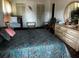 Main bedroom with closet space, dresser and large bed with bright comforter at 2659 Crown Ct # 11, Kissimmee, FL 34741