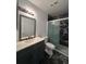 Modern bathroom with a black marble shower, stylish vanity, sleek fixtures, and ample lighting at 2804 N Powers Dr # 31, Orlando, FL 32818
