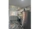 Updated kitchen with gray cabinets, stainless steel appliances, marble floors, and modern fixtures at 2804 N Powers Dr # 31, Orlando, FL 32818