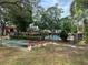 Outdoor shot of a pool with benches and nearby trees at 2804 N Powers Dr # 31, Orlando, FL 32818