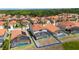 Aerial view of homes with orange tile roofs, blue bordered, and private screened-in pools at 301 Rosso Dr, Davenport, FL 33837
