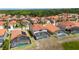 Aerial view of homes with orange tile roofs, and private screened-in pools at 301 Rosso Dr, Davenport, FL 33837
