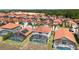 Community aerial view featuring homes with orange tile roofs and screened-in pools at 301 Rosso Dr, Davenport, FL 33837