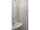 Bathroom with a round mirror and white basin sink at 301 Rosso Dr, Davenport, FL 33837