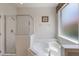 Bathroom with tub, shower, and window with lots of natural light at 301 Rosso Dr, Davenport, FL 33837