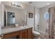 Bathroom with a vanity, toilet, and tub/shower combination, featuring a round window for natural light at 301 Rosso Dr, Davenport, FL 33837