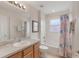 Bright bathroom with a shower and tub combination with patterned curtain at 301 Rosso Dr, Davenport, FL 33837
