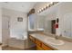 Bathroom features a tub with jets, a walk-in shower, and a large vanity at 301 Rosso Dr, Davenport, FL 33837