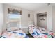A bedroom with two twin beds, a window with blinds, and a closet at 301 Rosso Dr, Davenport, FL 33837