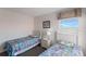 Bedroom featuring two twin beds with Mario-themed bedding and twin windows at 301 Rosso Dr, Davenport, FL 33837