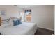 Well-lit bedroom with neutral walls, a queen-size bed and blue pillows at 301 Rosso Dr, Davenport, FL 33837
