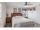 Comfortable bedroom featuring a ceiling fan, wood furnishings and relaxing natural light from the window at 301 Rosso Dr, Davenport, FL 33837