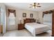Carpetless bedroom with tiled flooring, ceiling fan, and matching bedside tables and lamps at 301 Rosso Dr, Davenport, FL 33837