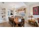 Formal dining room with a large wooden table, chandelier, and decorative alcoves, great for entertaining at 301 Rosso Dr, Davenport, FL 33837