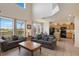 Open-concept living room flowing into a modern kitchen, featuring comfortable seating and backyard views at 301 Rosso Dr, Davenport, FL 33837
