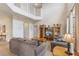 Bright living room with a soaring ceiling, an entertainment center, and views of the upper level at 301 Rosso Dr, Davenport, FL 33837