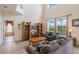 Spacious living room with high ceilings, large windows overlooking the pool, and a comfortable seating area at 301 Rosso Dr, Davenport, FL 33837