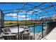 Relaxing screened-in pool area with patio furniture, perfect for outdoor enjoyment at 301 Rosso Dr, Davenport, FL 33837