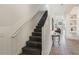 Bright stairway with white railings and table, leading to the second floor at 301 Rosso Dr, Davenport, FL 33837