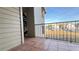 An outdoor balcony featuring tiled flooring with an iron railing and parking area views at 3038 Parkway Blvd # 204, Kissimmee, FL 34747