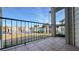View from a balcony with black metal railing overlooking a grassy common area and apartment buildings in the complex at 3038 Parkway Blvd # 204, Kissimmee, FL 34747