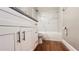 Bathroom showcases a marble vanity, white cabinets, and a marble-tiled shower-tub combination at 3038 Parkway Blvd # 204, Kissimmee, FL 34747