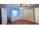 This bedroom features a ceiling fan, wood-look floors, and a window, with a closet at 3038 Parkway Blvd # 204, Kissimmee, FL 34747