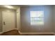 Bright foyer with hardwood flooring, white door, and a large window at 3038 Parkway Blvd # 204, Kissimmee, FL 34747