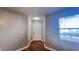 Clean, neutral-toned foyer with wood floors and a white entry door at 3038 Parkway Blvd # 204, Kissimmee, FL 34747