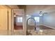 Updated kitchen with stainless sink, granite countertops and view into the spacious living area at 3038 Parkway Blvd # 204, Kissimmee, FL 34747