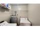 Functional laundry area with shelving, updated water heater, and well-maintained washer/dryer at 3038 Parkway Blvd # 204, Kissimmee, FL 34747