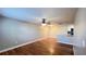 Open-concept living area with wood floors, ceiling fan, and a view of the modern kitchen at 3038 Parkway Blvd # 204, Kissimmee, FL 34747