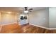 Bright living room with hardwood floors and a view into the kitchen with stainless appliances at 3038 Parkway Blvd # 204, Kissimmee, FL 34747