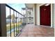 Patio with outdoor space, featuring tiled flooring and a red front door to the unit at 3038 Parkway Blvd # 204, Kissimmee, FL 34747