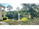 View of a pond with fountain and trees from a balcony at 3038 Parkway Blvd # 204, Kissimmee, FL 34747