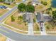 Aerial view of a house with an extensive driveway surrounded by well-maintained landscapes in a neighborhood at 3160 Santa Cruz Dr, Kissimmee, FL 34746