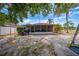 Backyard featuring a covered porch, swing set, and grassy area, great for outdoor fun at 3160 Santa Cruz Dr, Kissimmee, FL 34746