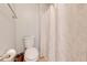Bright bathroom featuring a toilet and shower with a patterned shower curtain at 3160 Santa Cruz Dr, Kissimmee, FL 34746