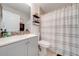 Bathroom with a vanity, toilet, and shower featuring a striped shower curtain at 3160 Santa Cruz Dr, Kissimmee, FL 34746
