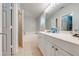 Bright bathroom featuring a double sink vanity with white cabinets and a shower-tub combination at 3160 Santa Cruz Dr, Kissimmee, FL 34746