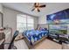 Bedroom with a closet, TV, and a large window, providing ample natural light at 3160 Santa Cruz Dr, Kissimmee, FL 34746