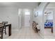 Inviting foyer with tile flooring, white front door, and an archway to the bedroom at 3160 Santa Cruz Dr, Kissimmee, FL 34746