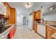 Well-equipped kitchen boasting granite counters, wood cabinetry, white appliances, and tile floors at 3160 Santa Cruz Dr, Kissimmee, FL 34746