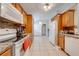 Updated kitchen featuring granite countertops, modern appliances, wood cabinets, and bright tile flooring at 3160 Santa Cruz Dr, Kissimmee, FL 34746
